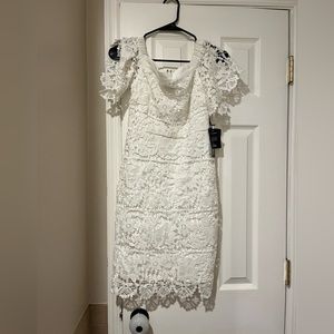 Lulus white lace dress. It is form fitting and hits just above knees.